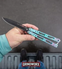 Bear Ops Bear Song IV Cyan Speckle Blue Butterfly Knife - Black -Gerber Knives Store Bear Ops Bear Song IV Butterfly Knife Cyan Speckle Blue Black BHQ 83465 kp in hand web large